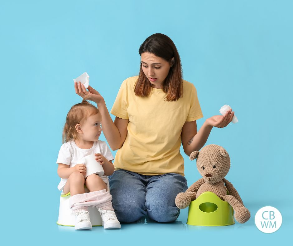 Mom with her child on a potty chair