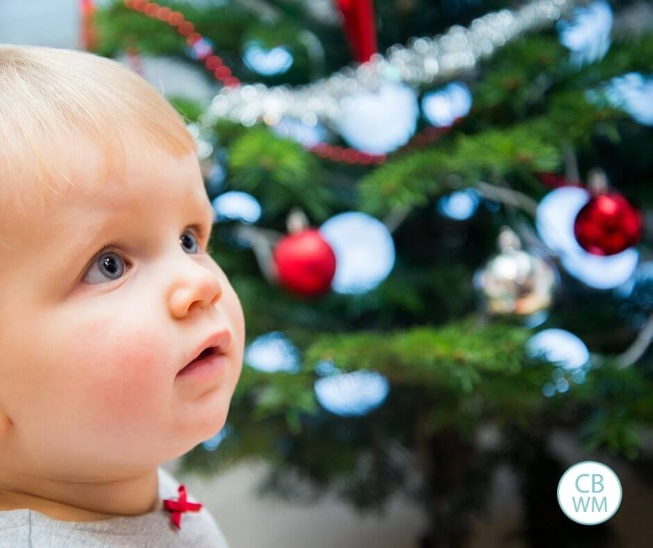 Should You Baby-Proof Your Christmas Tree or teach baby to not touch the ornaments on the tree? Baby at the Christmas tree