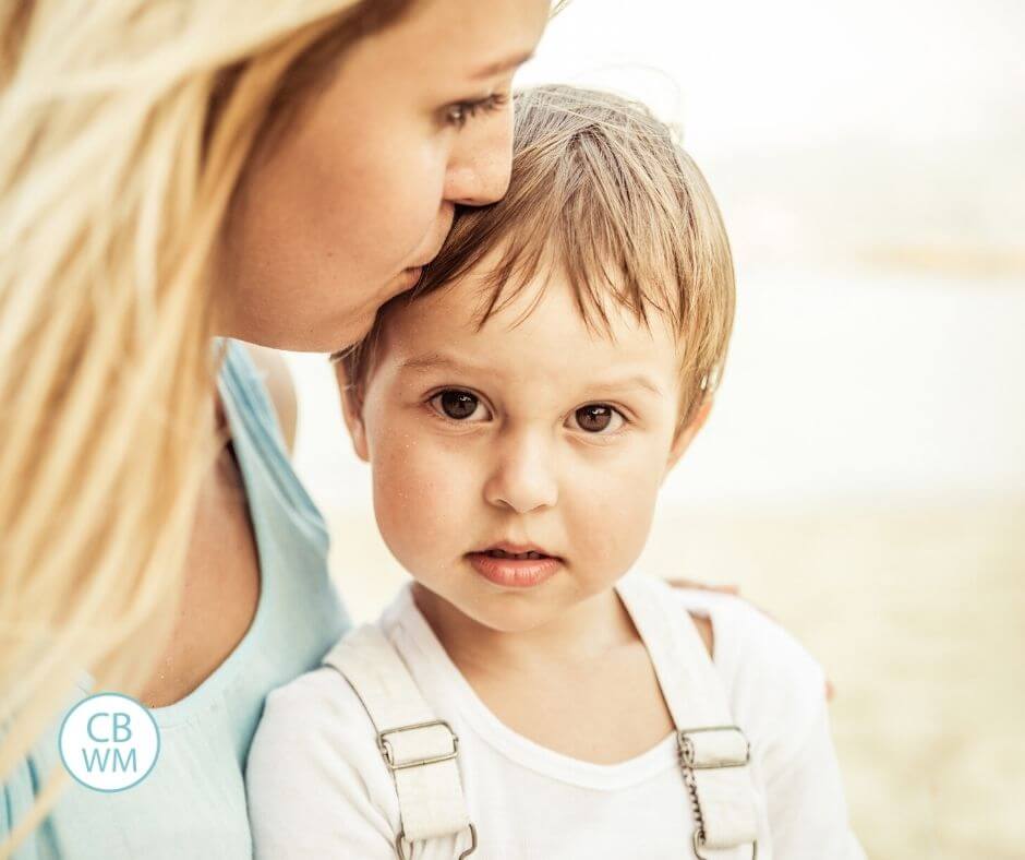 Mom kissing son