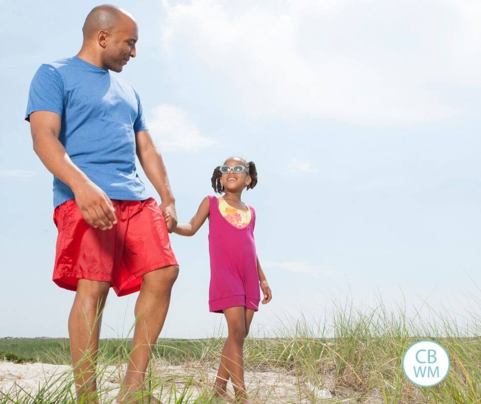 Father and daughter walking on the beach