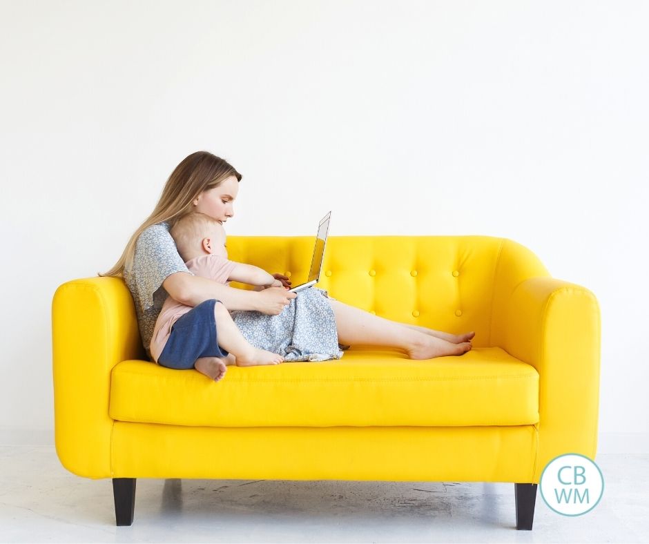 Mom and child looking at computer on couch