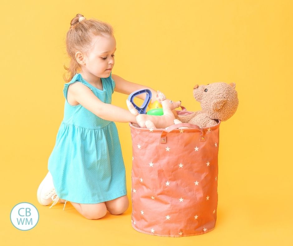 Girl with bin of toys