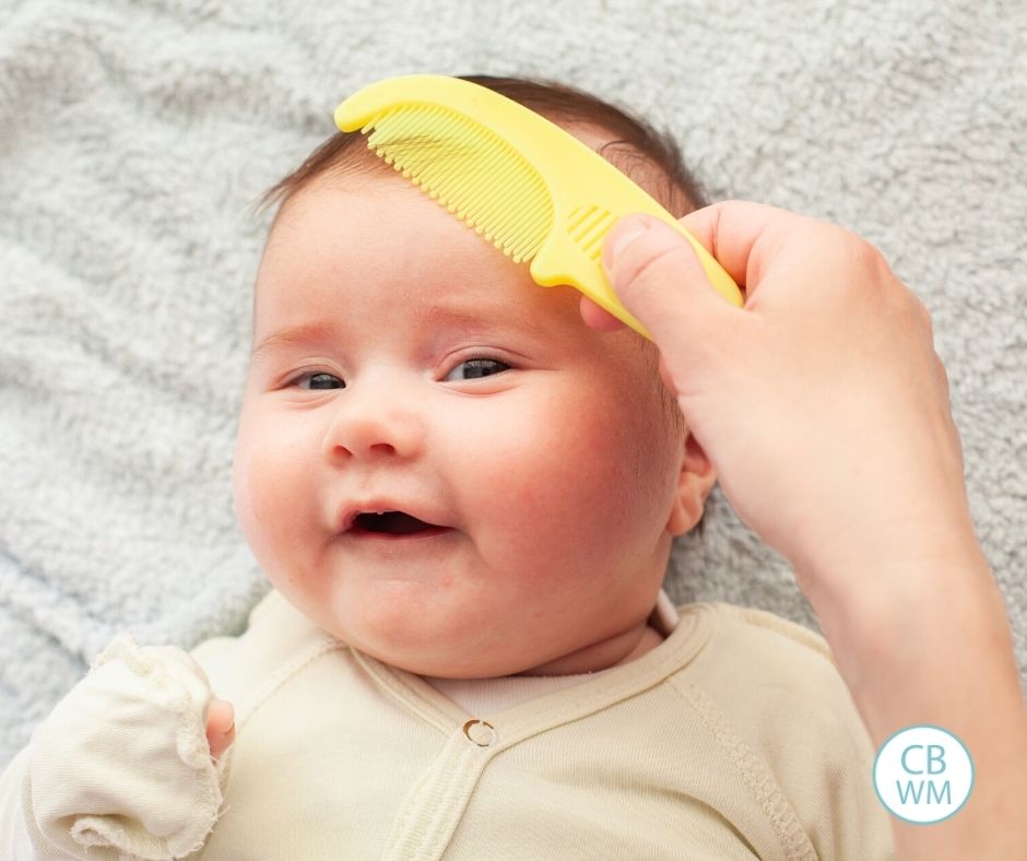 Baby getting hair combed