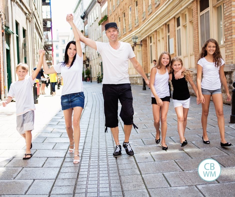 Family walking down the street holding hands