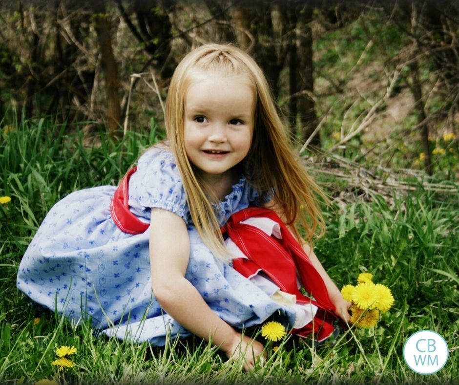 Kaitlyn 4.25 picking flower wearing blue dress