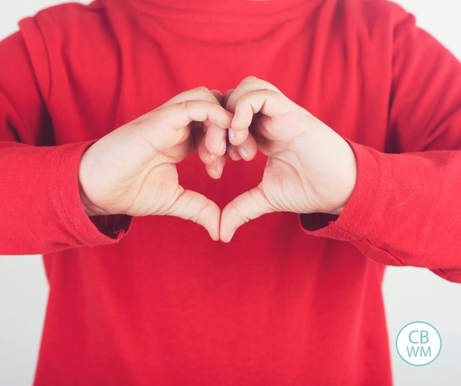 Child making a heart with hands