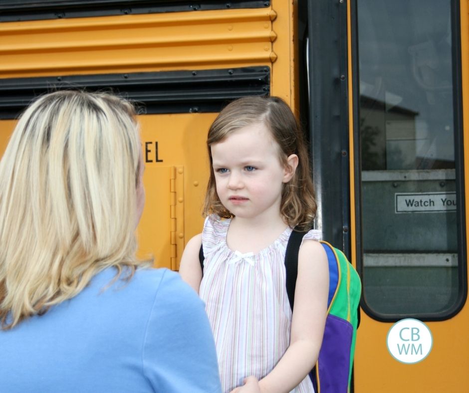 Mom correcting child before she gets on the bus