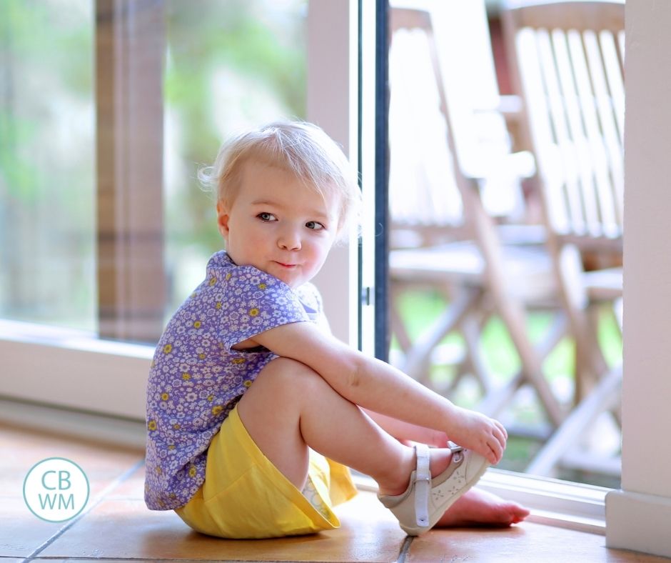 Toddler putting on shoes