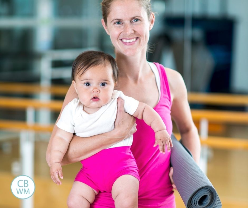 Mom ready to exercise holding a baby