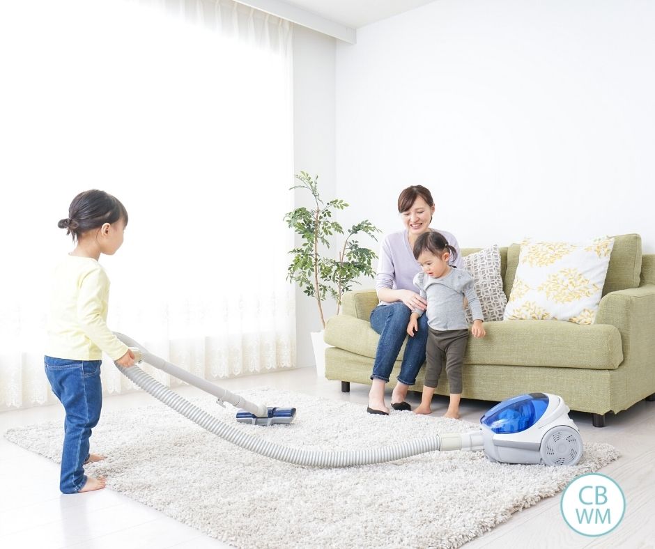 Child vacuuming the floor