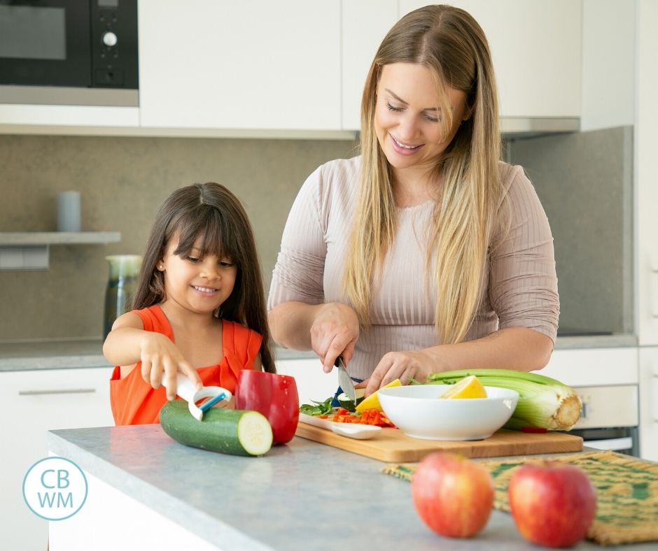 mom and daughter making meal together