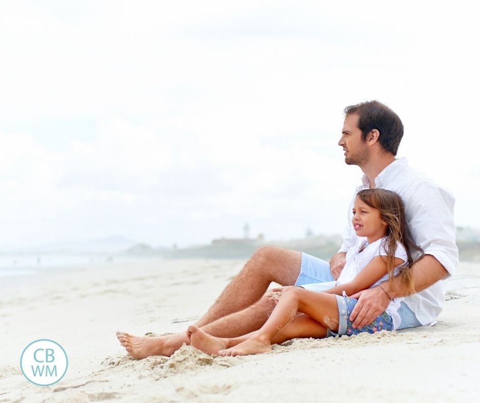 Dad and daughter sitting on the bed