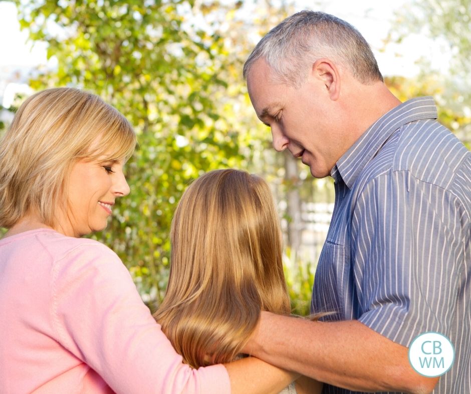 mom and dad talking to daughter