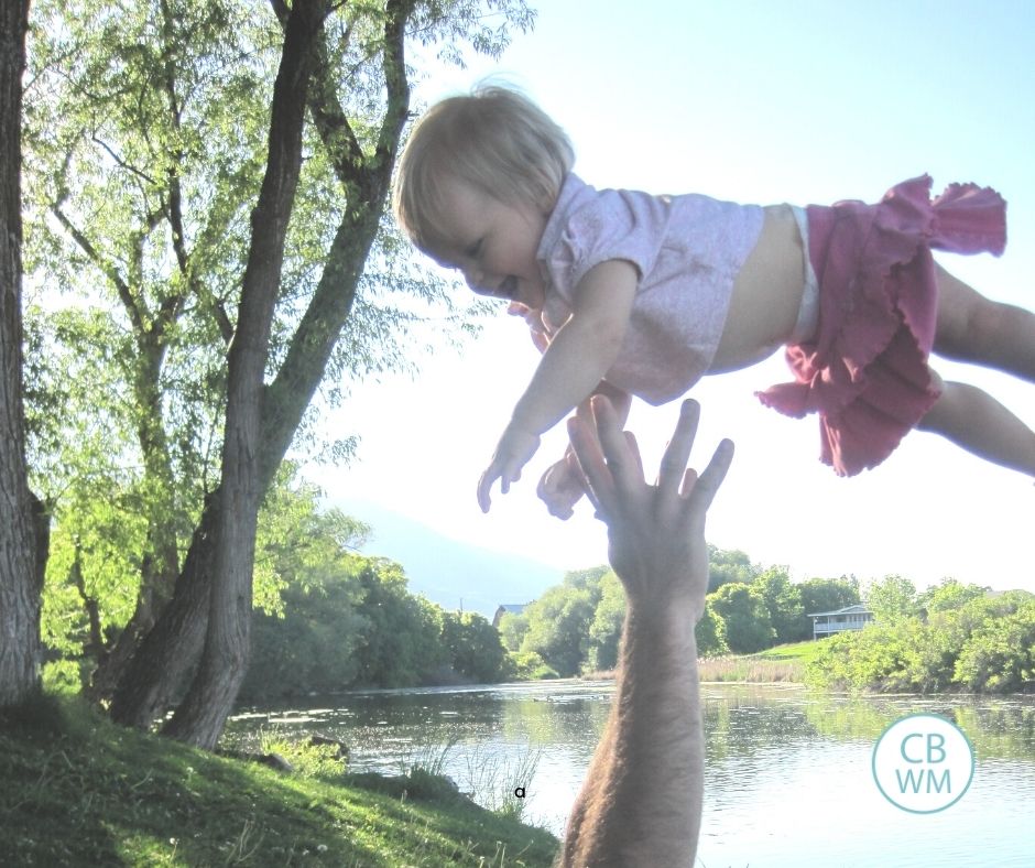 pretoddler McKennna being thrown in the air