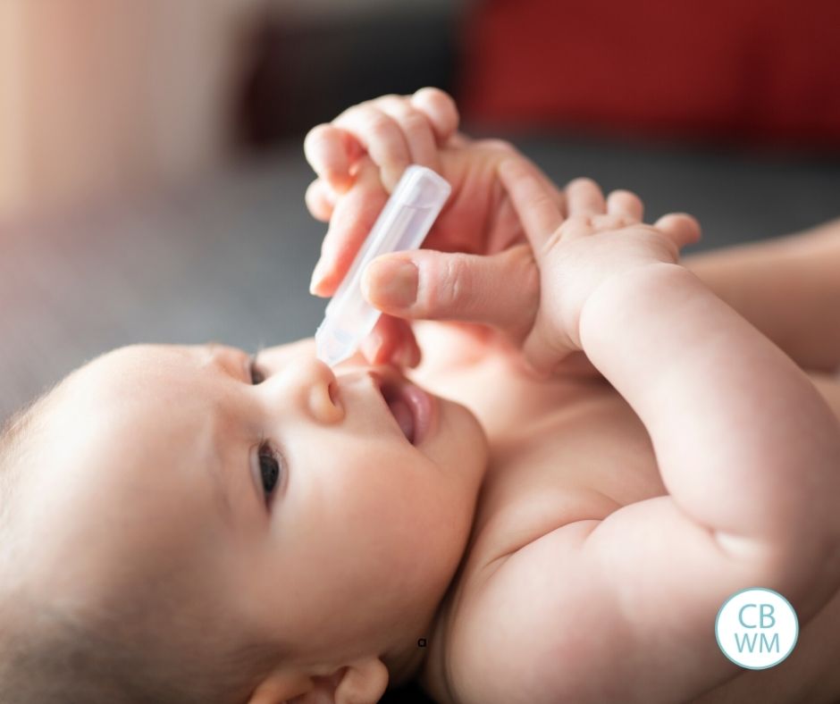 Mother addressing baby's nose