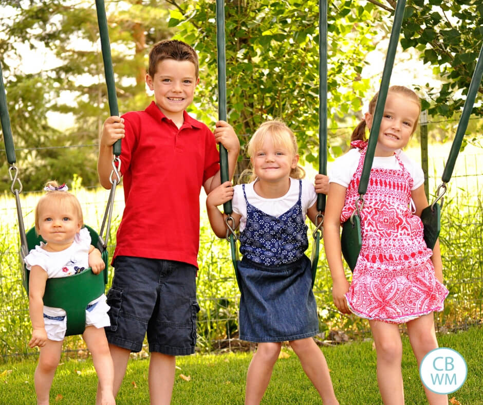 Four children sitting on swings