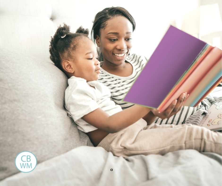mom reading to her daughter in bed