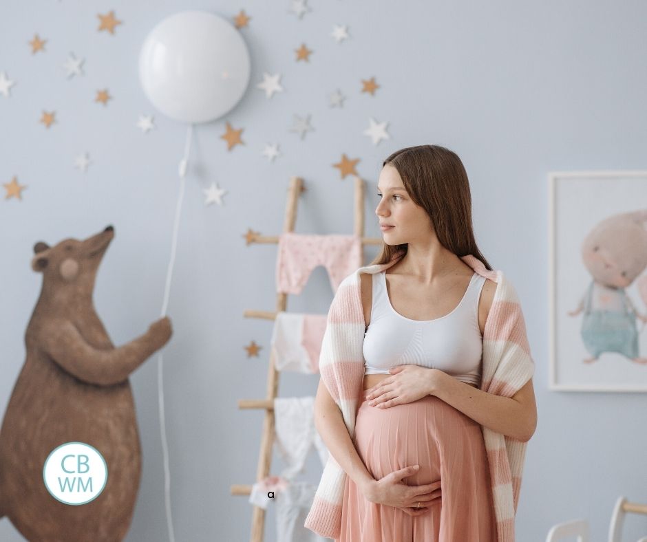 Pregnant woman standing in baby's nursery