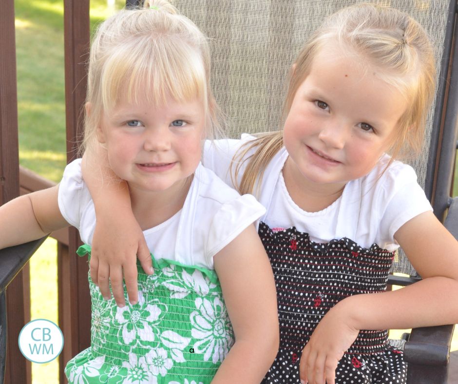 Two sisters sitting in a chair together