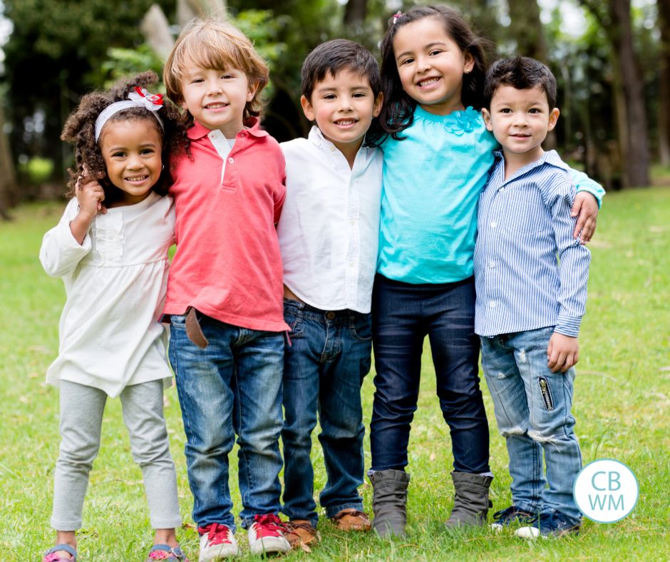 Five children lined up and smiling for the camera