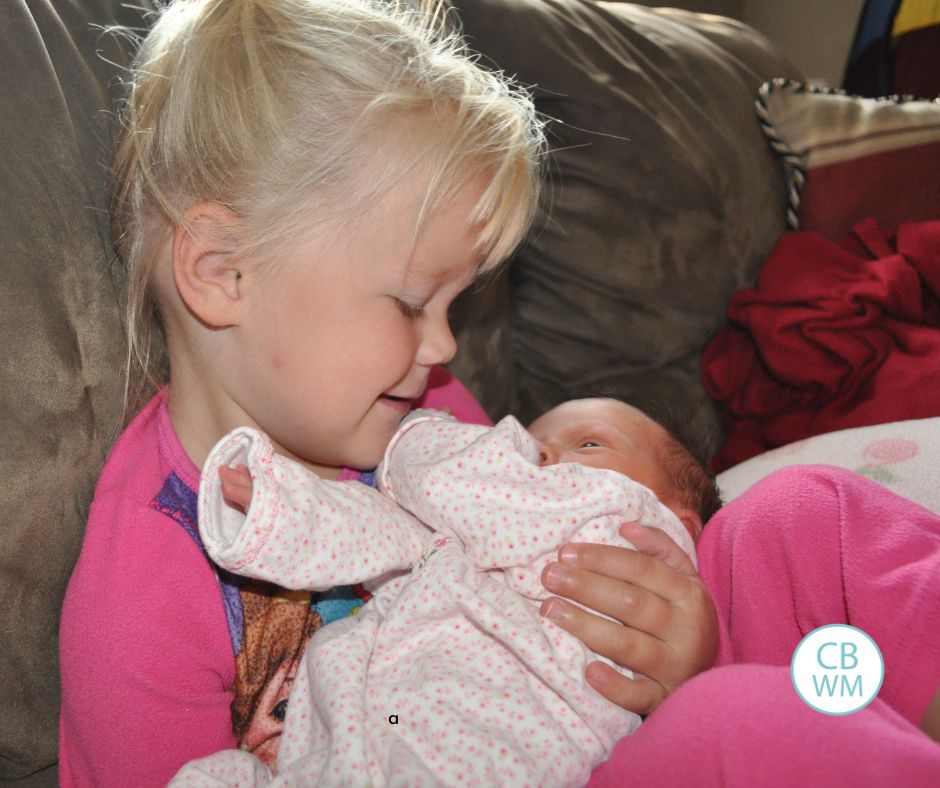 3 year old McKenna holding baby Brinley