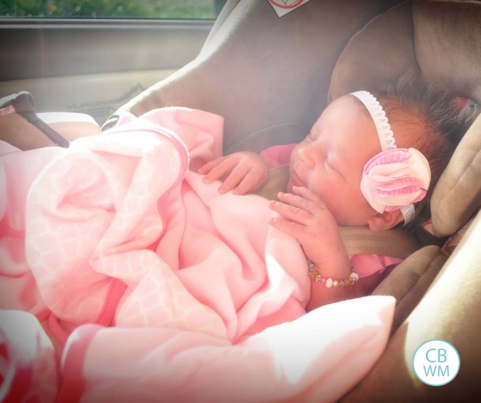 Newborn Brinley in the car seat in the car.