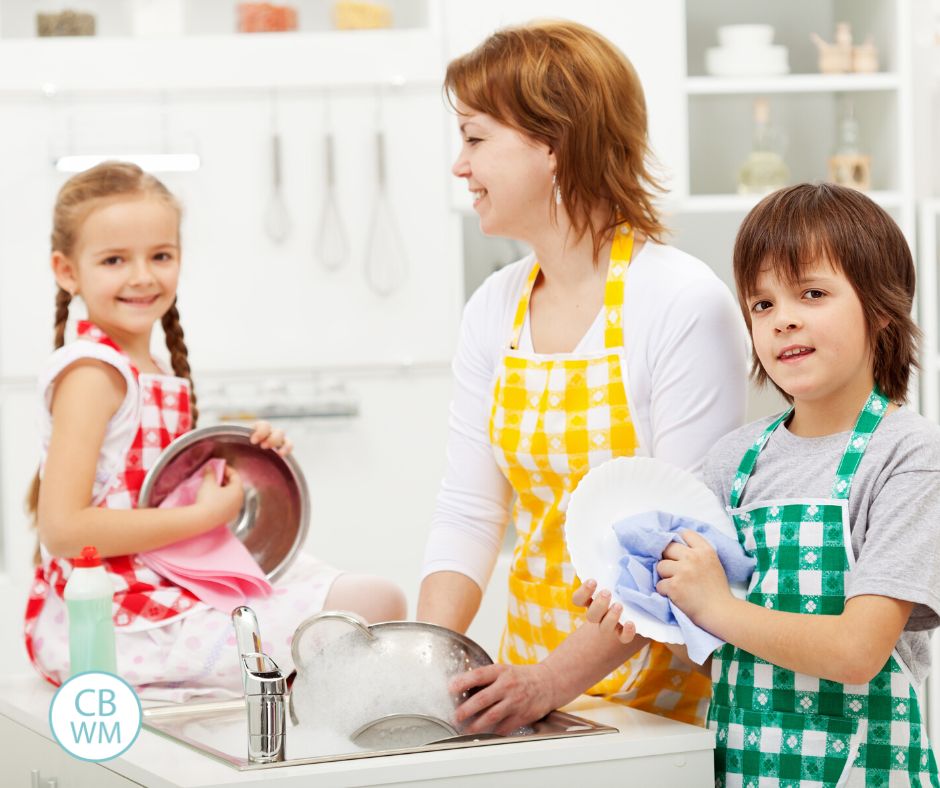 Children doing dishes with their mom