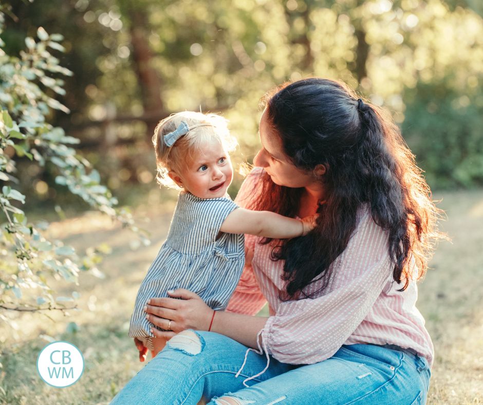 Mom holding toddler having a tantrum