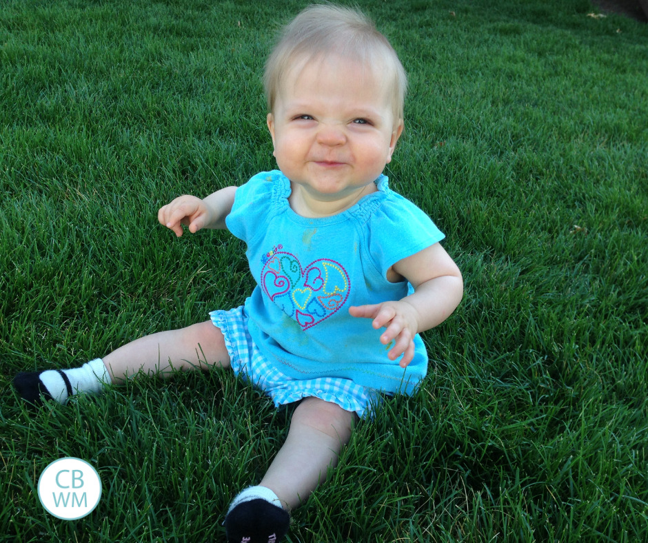 Brinley sitting on the grass