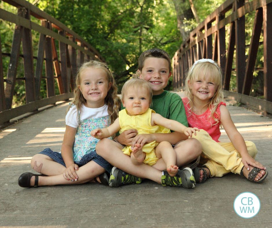 Plowman kids sitting on a bridge.