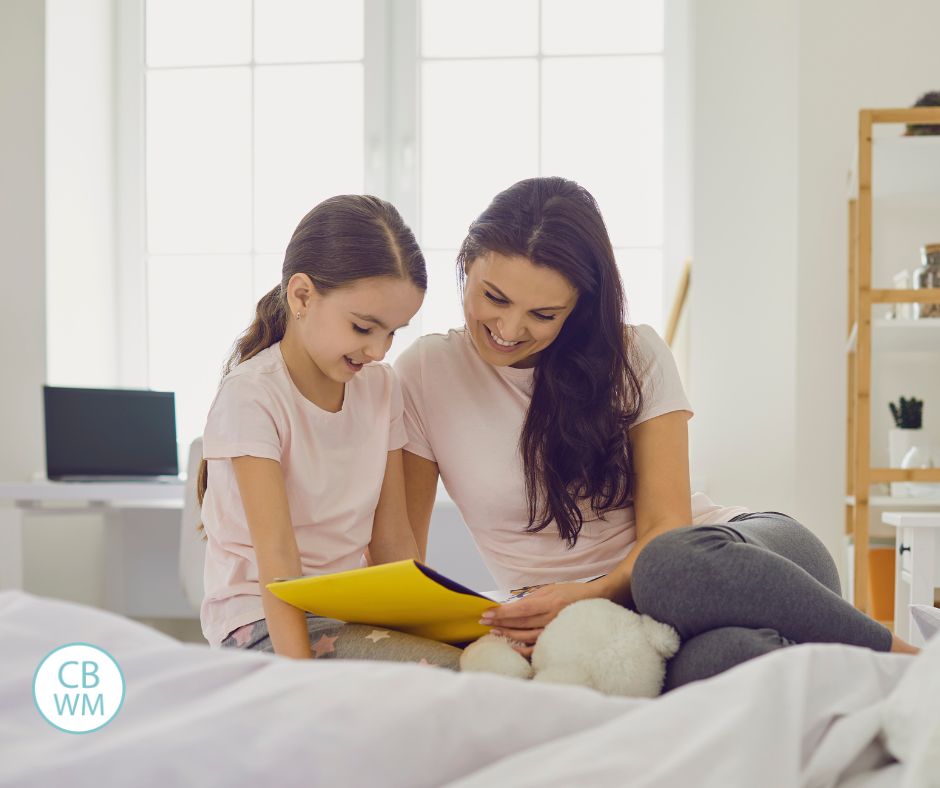 Mom and child sitting on the bed. 