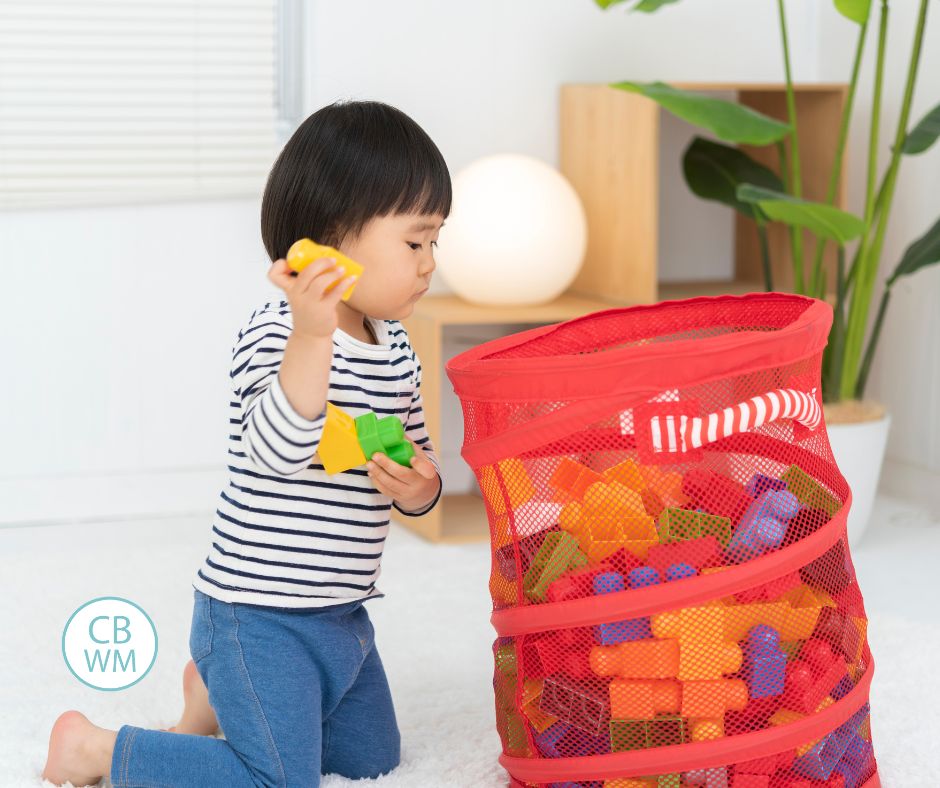 child cleaning up legos