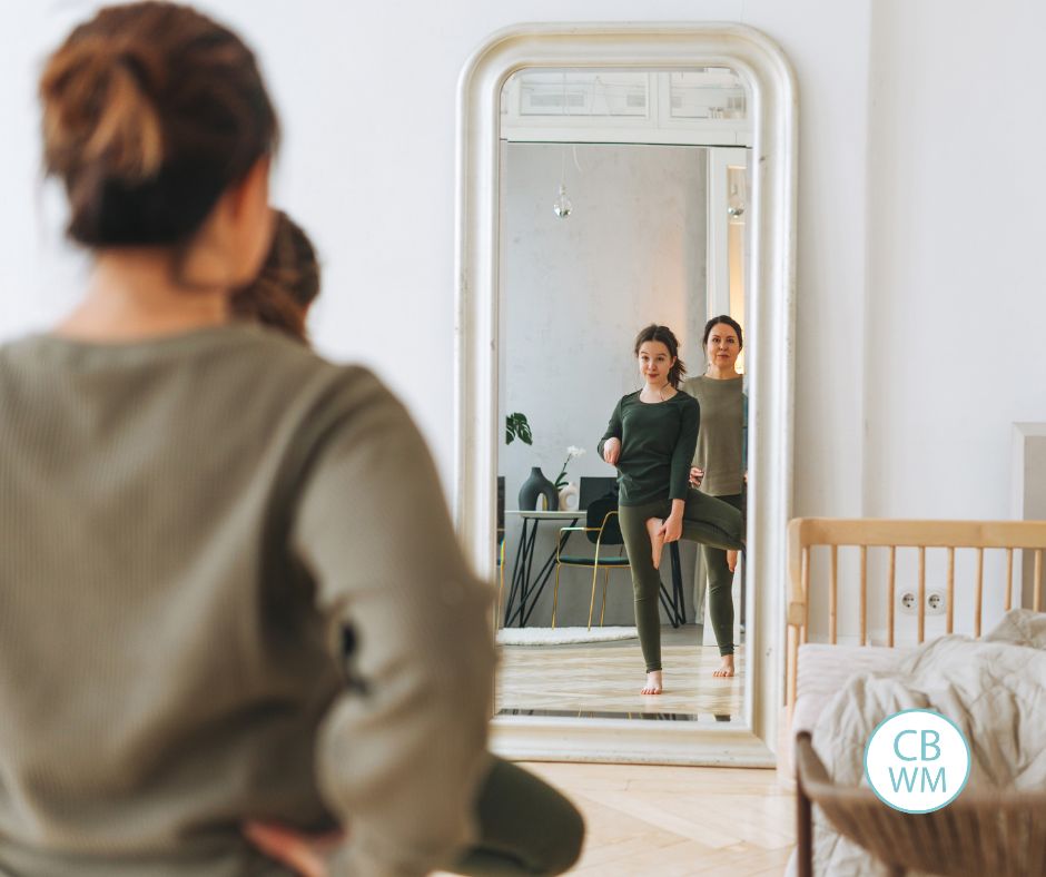 Mom and daughter looking in the mirror