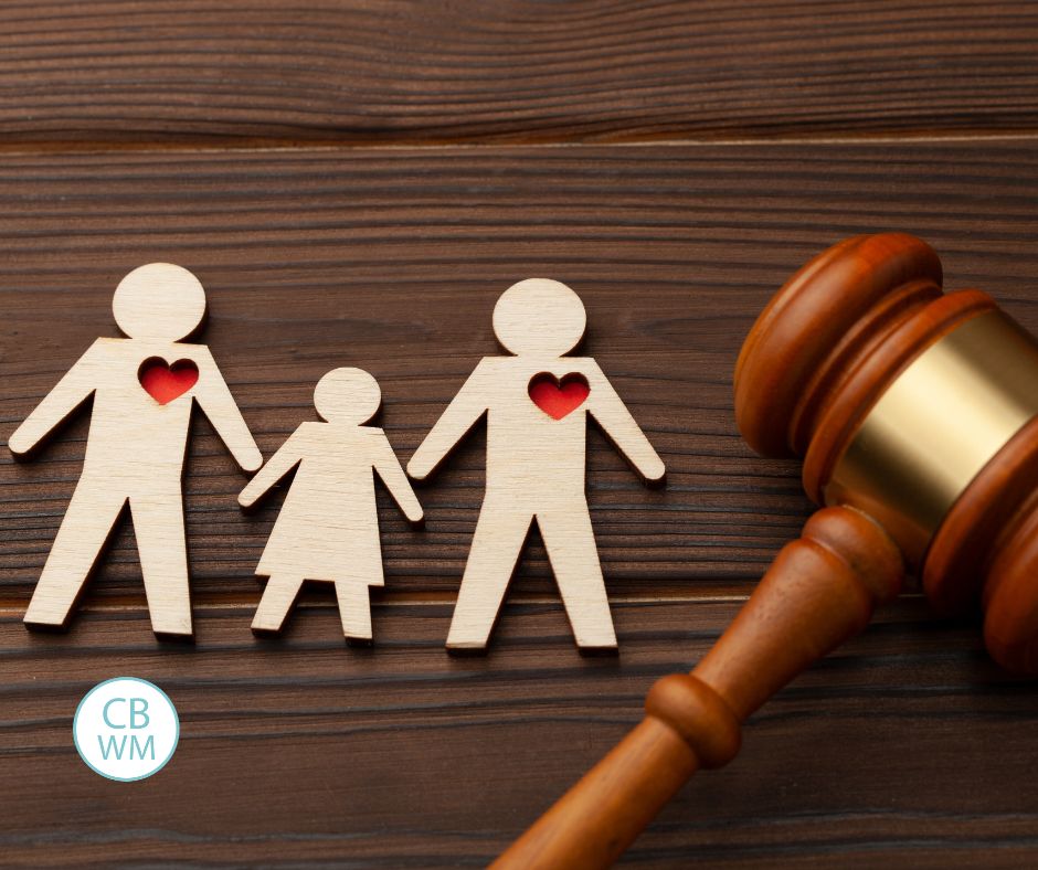 picture of 3 cutout people and a judge mallet to signify adoption