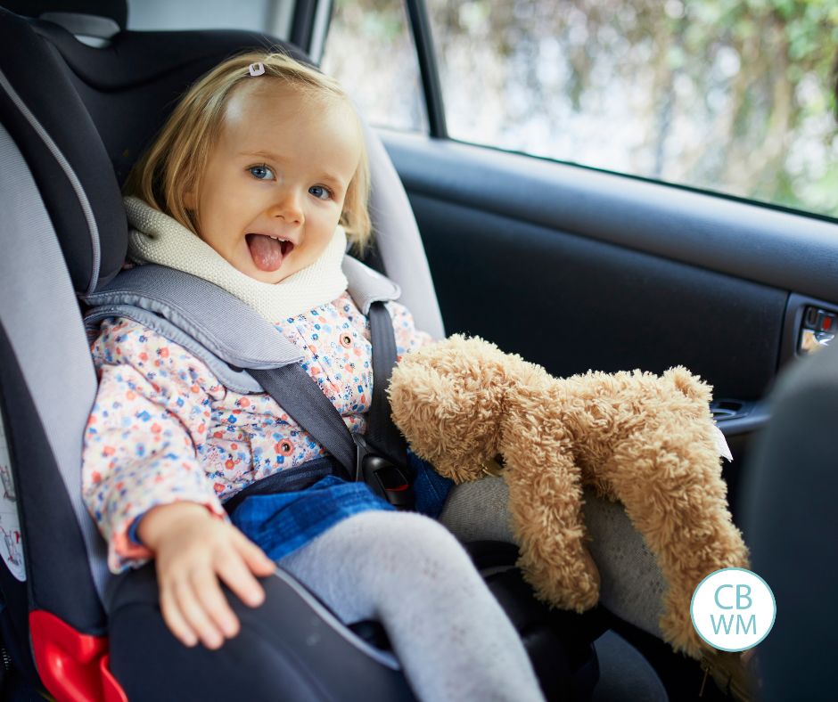 Child sitting in a car seat with a coat on