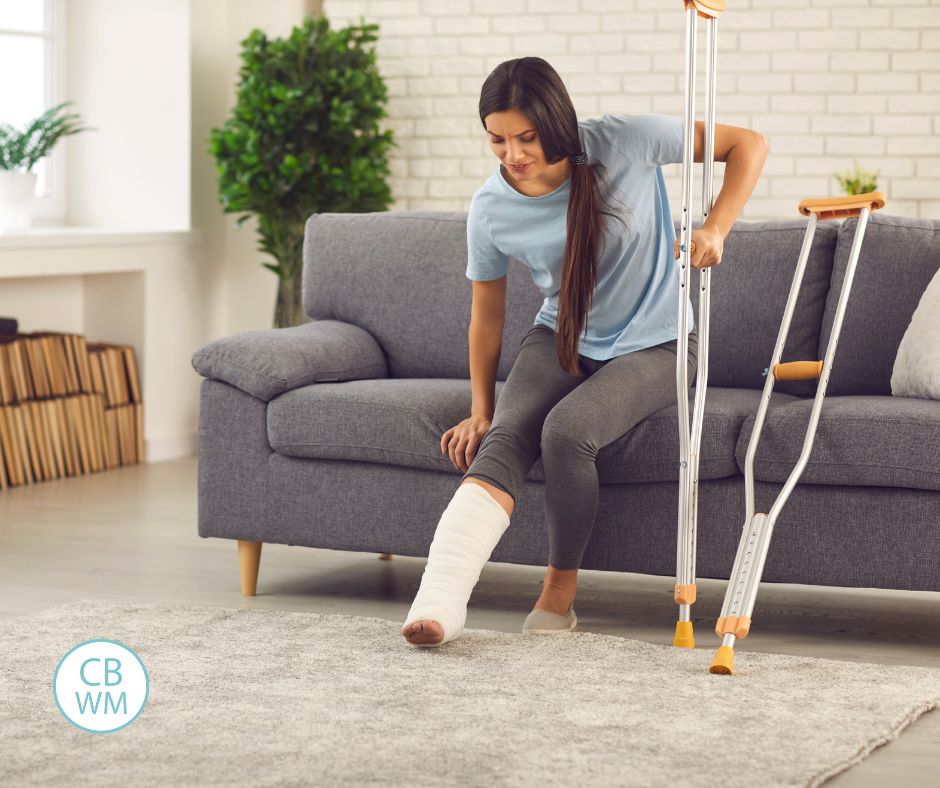 woman on crutches sitting on the couch