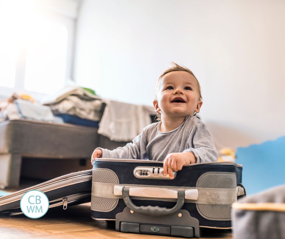 Baby in a suitcase in a hotel room