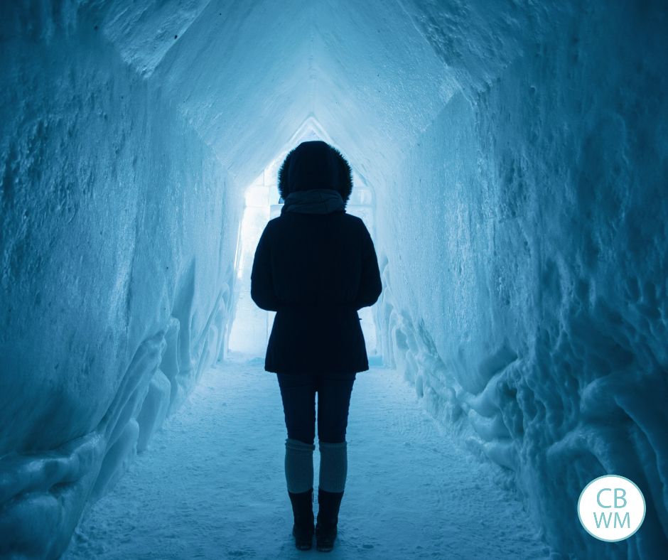 woman standing in an ice tunnel