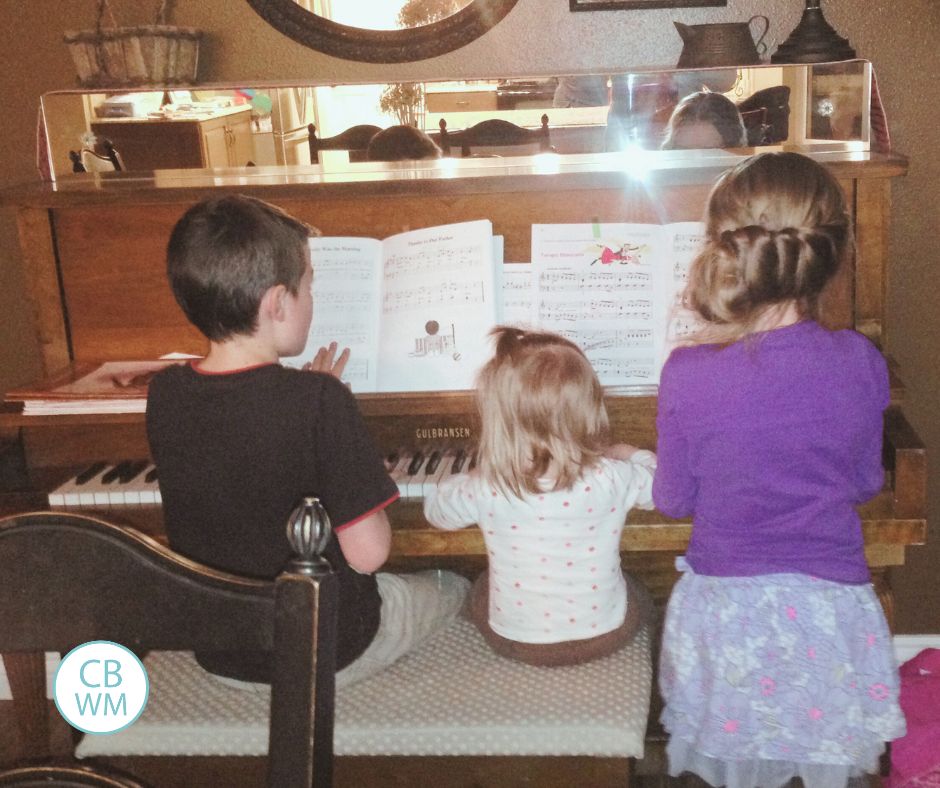 Brayden, Brinley, and Kaitlyn sitting at the piano. 
