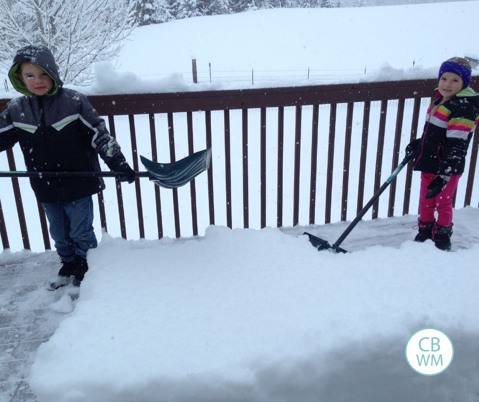 Brayden and Kaitlyn shoveling snow on our deck
