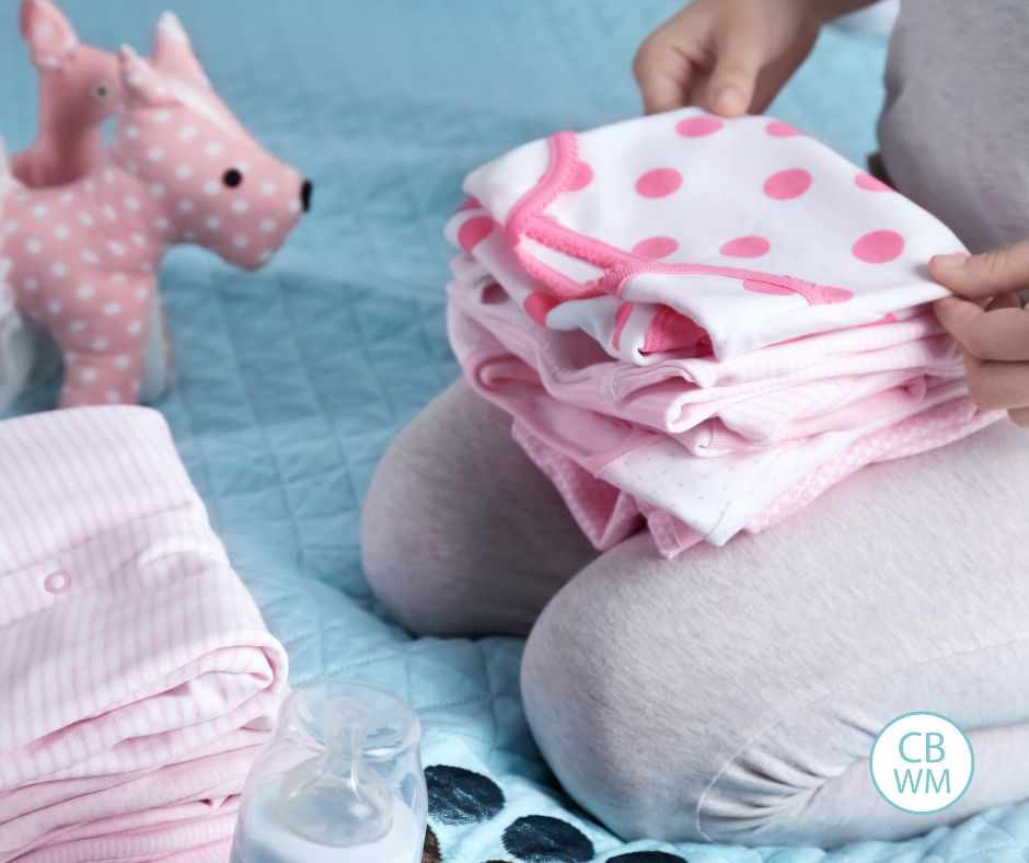 mom folding babys laundry