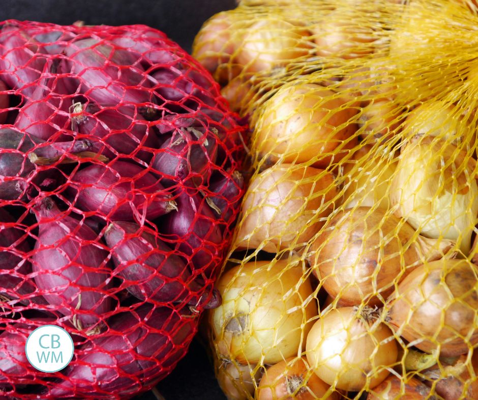Red and yellow onion sets in bags