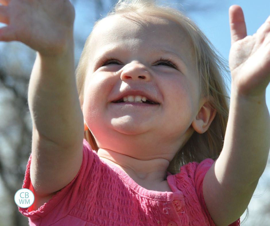 Brinley looking to the sky with her hands raised