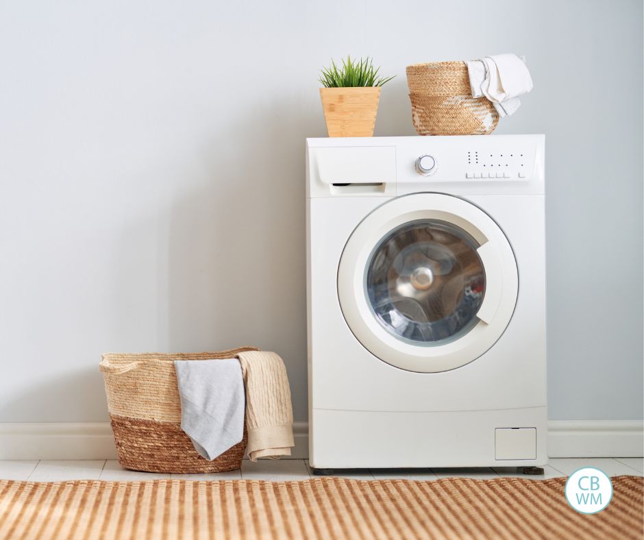 dryer with a basket on the ground next to it