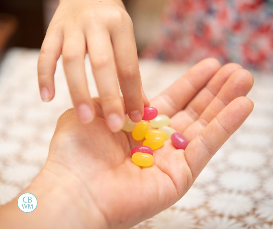 Parent holding candy for child