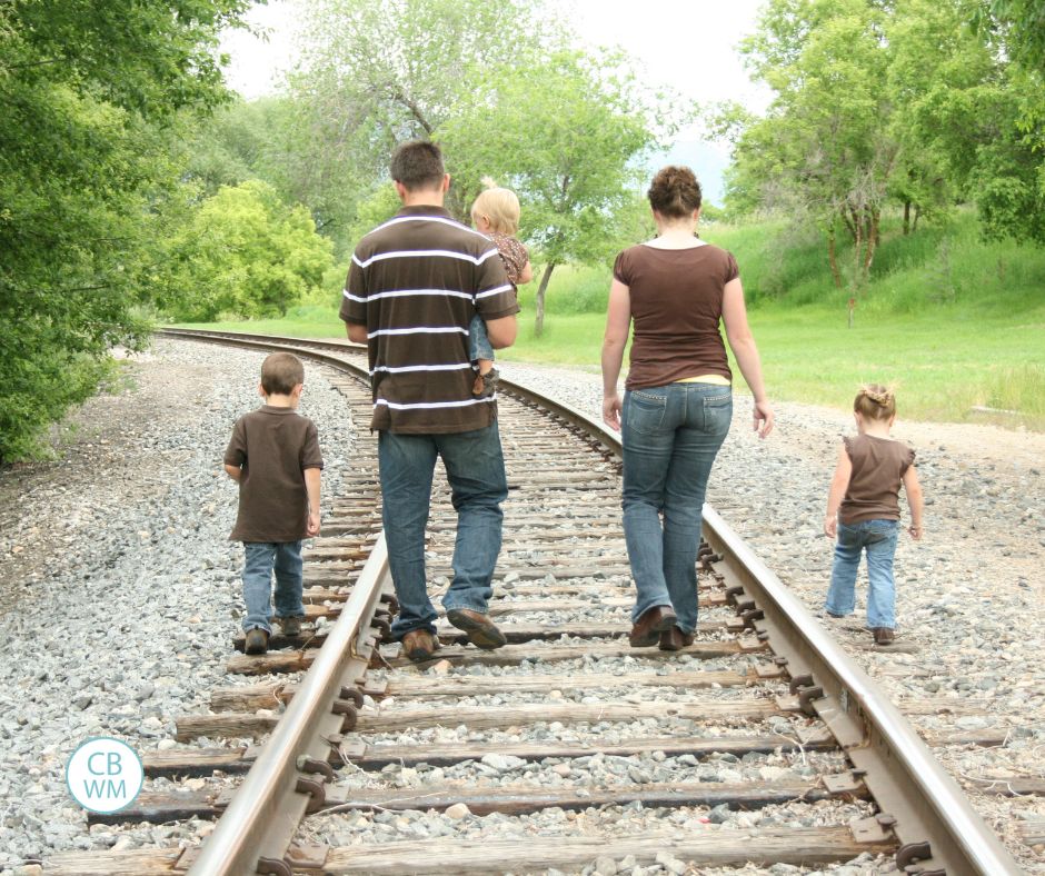 family walking down the train tracks