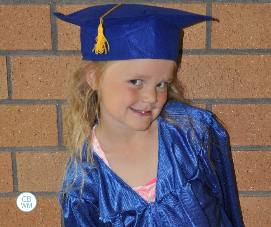 McKenna wearing a cap and gown at her preschool graduation