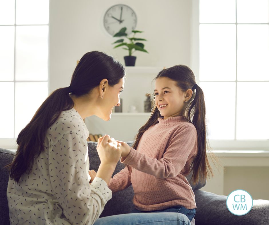 mother talking to her daughter on the couch