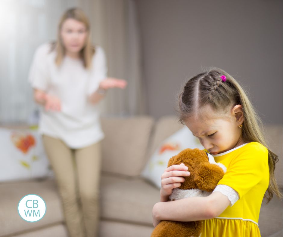 Mom getting mad at he daughter who is holding a stuffed animal