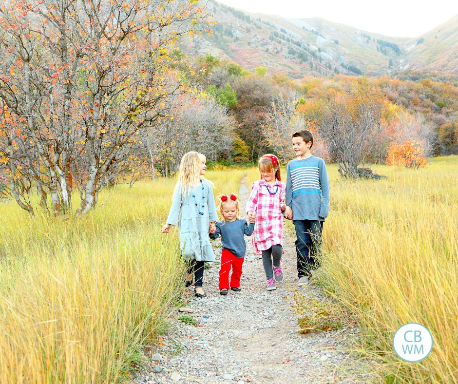 Siblings walking down a path together